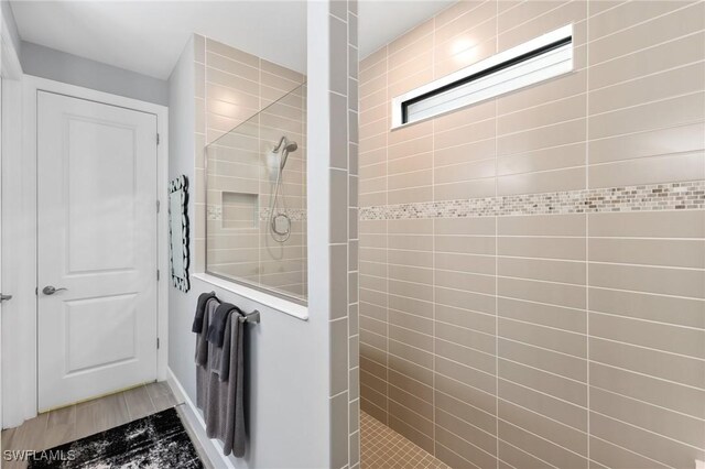 bathroom with a tile shower