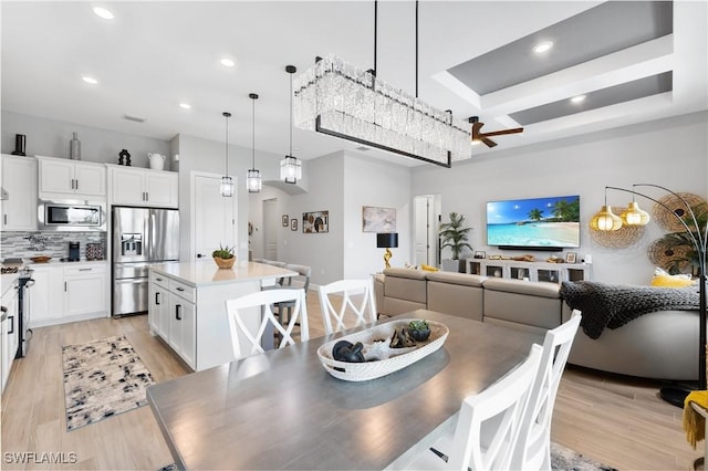 dining space with light wood-style floors and recessed lighting