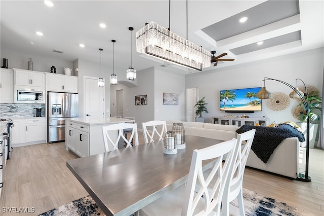2740 Amaranda Ct, Naples, FL 34114 - dining room with arched walkways, recessed lighting, and light wood finished floors