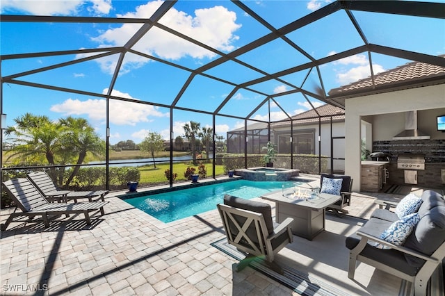 2740 Amaranda Ct, Naples, FL 34114 - view of pool with a pool with connected hot tub, exterior kitchen, glass enclosure, and a patio area