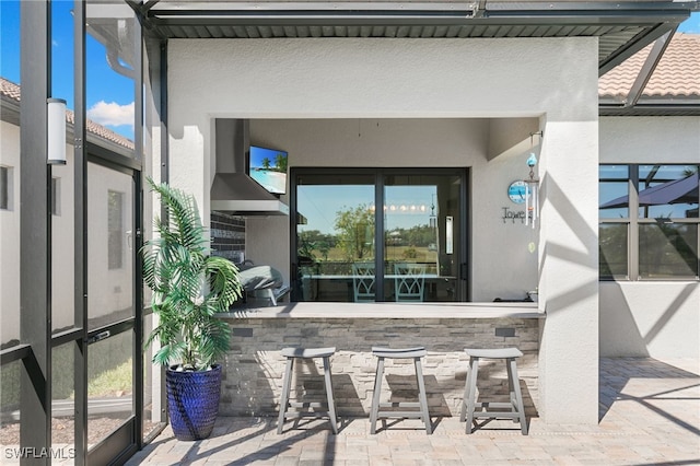 2740 Amaranda Ct, Naples, FL 34114 - view of patio with outdoor dry bar, area for grilling, and a lanai