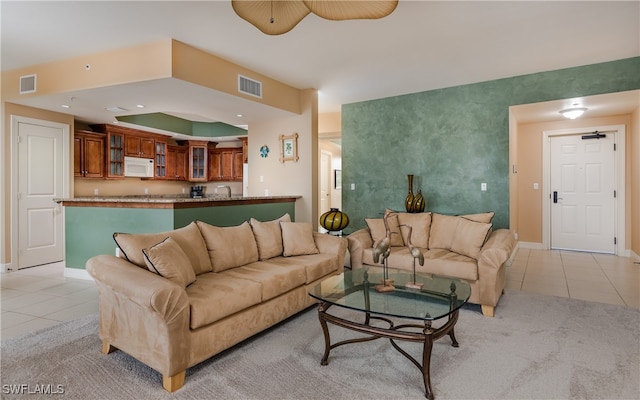 living room with sink and light tile patterned floors