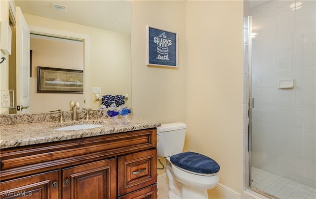 bathroom with a shower with door, toilet, and vanity