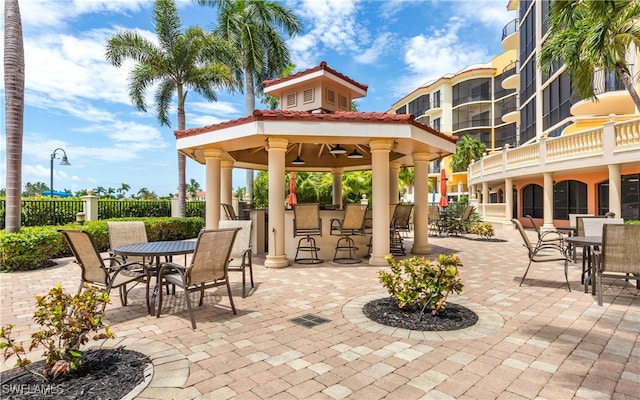 view of patio featuring a balcony and an outdoor bar