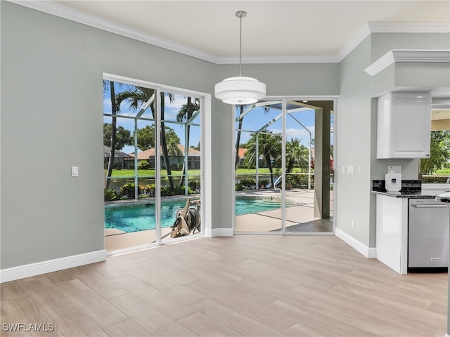 unfurnished dining area with crown molding, a healthy amount of sunlight, and light wood-type flooring