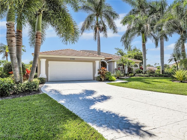 view of front of house with a garage and a front lawn