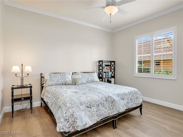 bedroom featuring ceiling fan, light hardwood / wood-style flooring, and crown molding