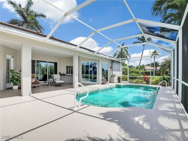 view of swimming pool with a lanai and a patio