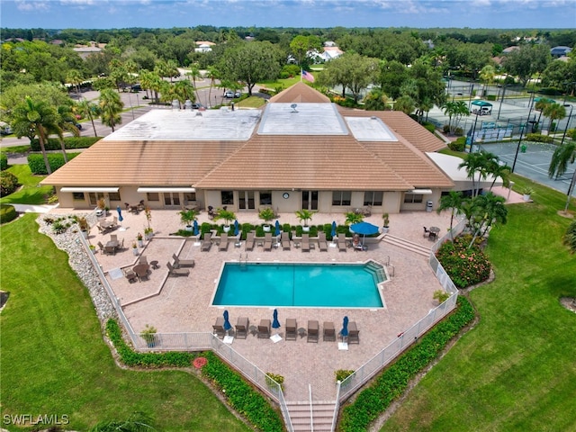 view of pool with a patio area and a lawn