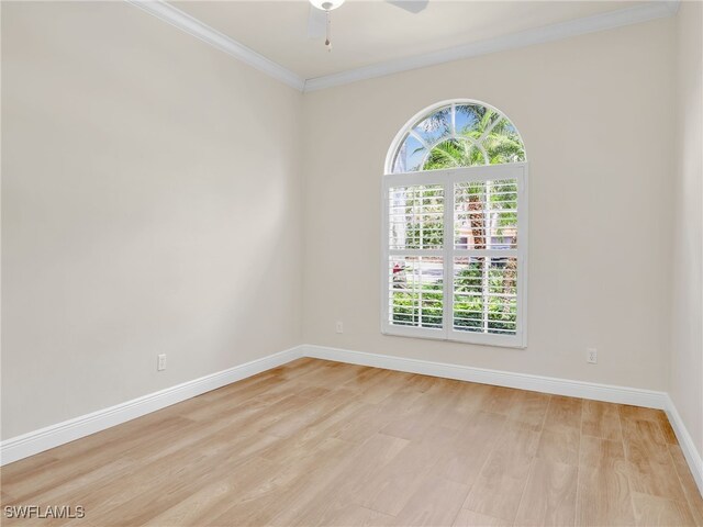 empty room featuring ceiling fan, light hardwood / wood-style floors, and ornamental molding