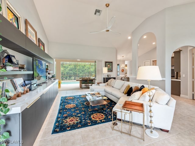 tiled living room featuring high vaulted ceiling and ceiling fan