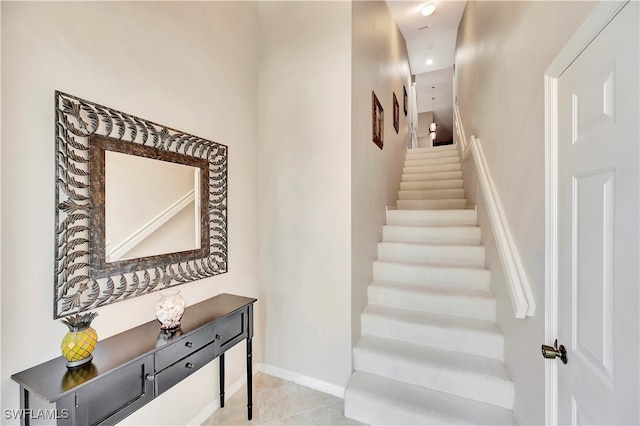 stairs with light tile patterned flooring