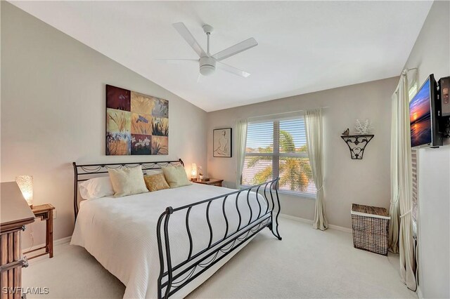 bedroom featuring ceiling fan, lofted ceiling, and light carpet