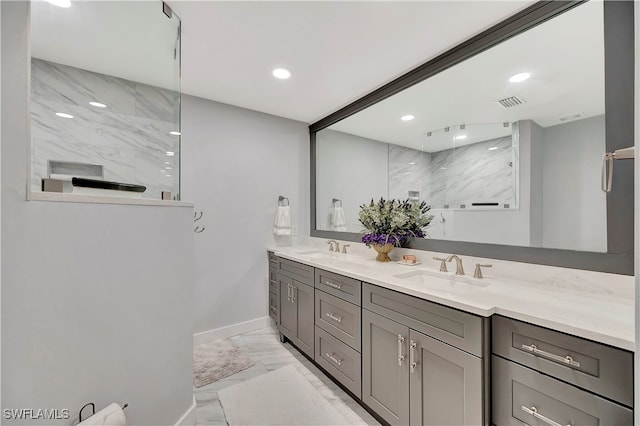 bathroom featuring dual bowl vanity and tile patterned flooring