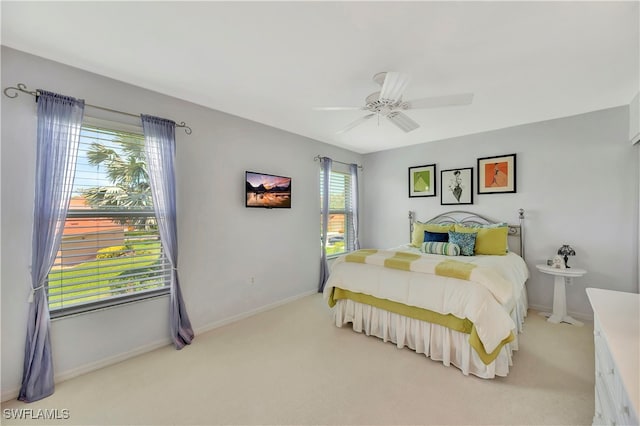 bedroom with ceiling fan and light carpet