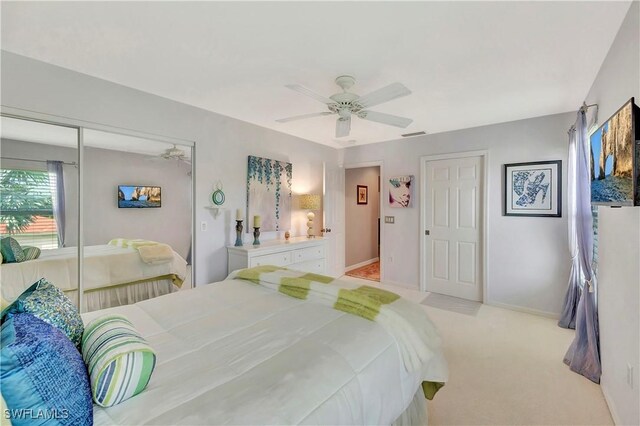 carpeted bedroom featuring a closet and ceiling fan