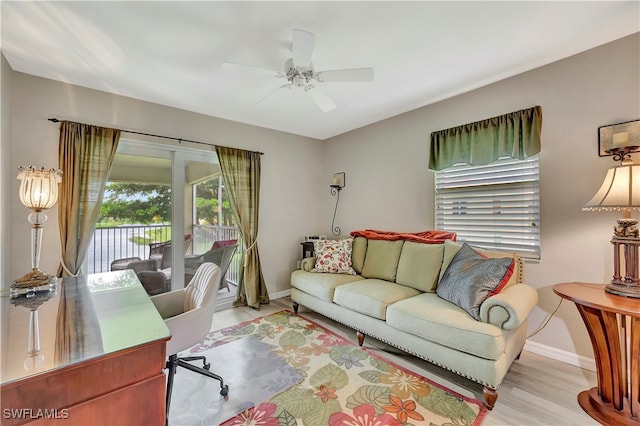 home office with ceiling fan and light wood-type flooring