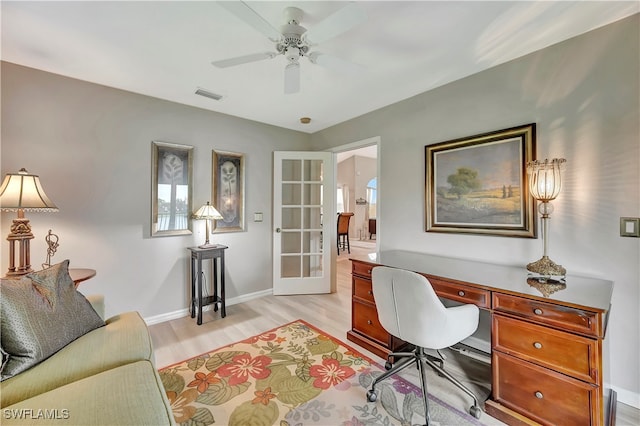 home office with ceiling fan, light wood-type flooring, and french doors