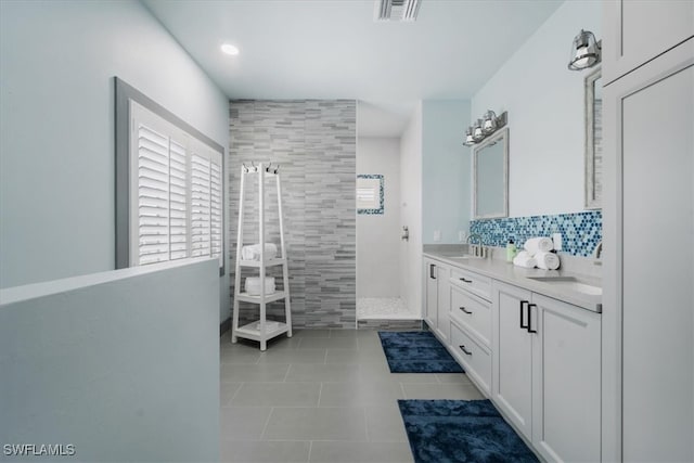 bathroom with tile patterned floors, vanity, walk in shower, and tile walls