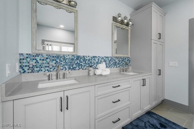 bathroom featuring tile patterned floors, vanity, and backsplash