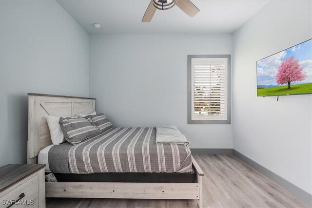 bedroom with ceiling fan and light hardwood / wood-style floors