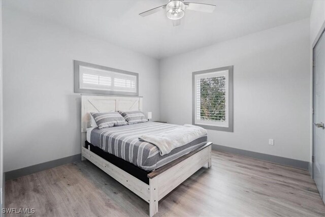 bedroom featuring ceiling fan and light hardwood / wood-style flooring