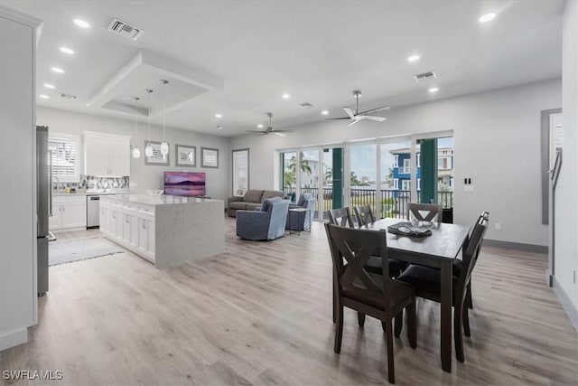 dining area with ceiling fan and light hardwood / wood-style floors