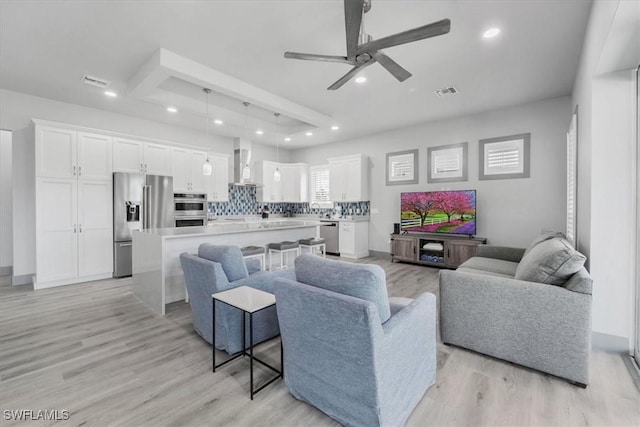 living room with light wood-type flooring and ceiling fan