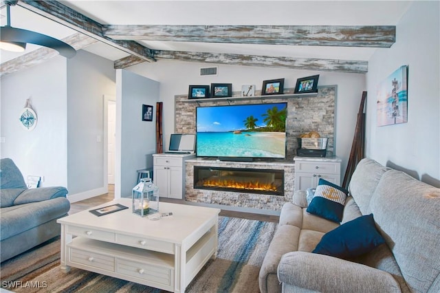 living room with hardwood / wood-style flooring and lofted ceiling with beams