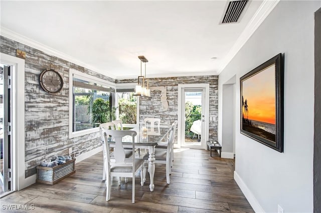 dining space featuring ornamental molding, plenty of natural light, and dark hardwood / wood-style floors