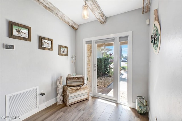 entryway with beamed ceiling and hardwood / wood-style flooring