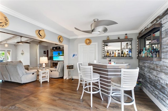 bar with dark hardwood / wood-style flooring, crown molding, and ceiling fan