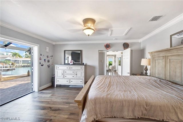 unfurnished bedroom with ornamental molding, a water view, dark wood-type flooring, and access to exterior