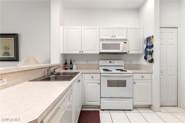 kitchen featuring white cabinetry, sink, light tile patterned floors, and white appliances