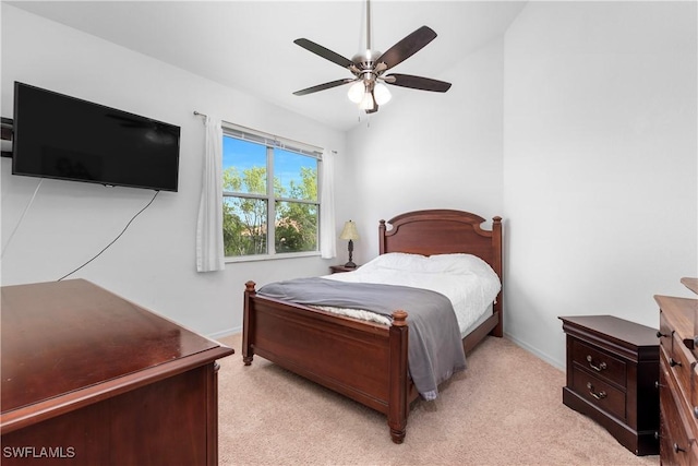 carpeted bedroom with vaulted ceiling and ceiling fan