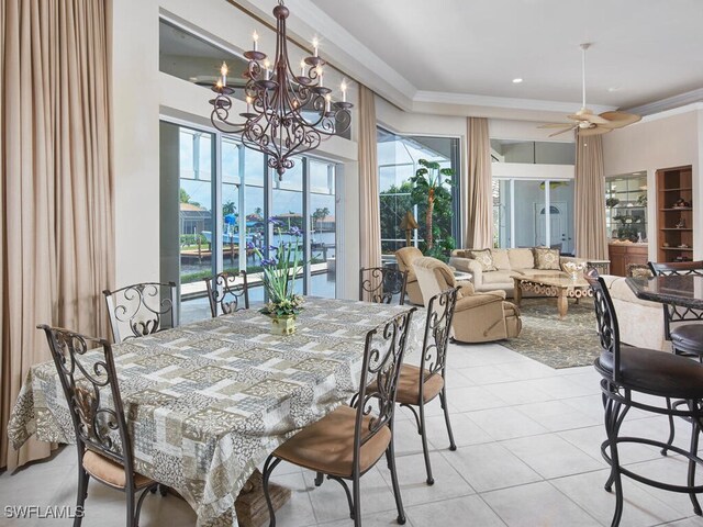 dining room featuring light tile patterned floors, ceiling fan with notable chandelier, and ornamental molding