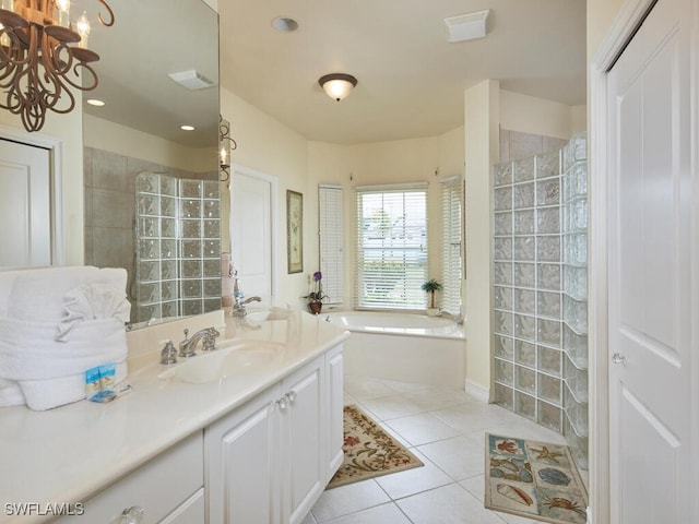 full bath featuring tile patterned flooring, vanity, visible vents, a bath, and walk in shower