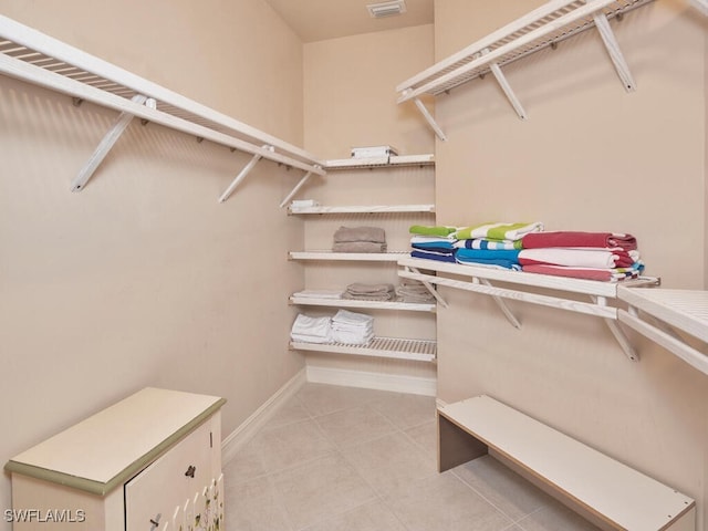 walk in closet featuring light tile patterned floors and visible vents