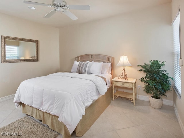 bedroom with baseboards, a ceiling fan, and light tile patterned flooring