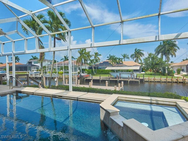 view of pool featuring a water view, an in ground hot tub, a dock, and a lanai