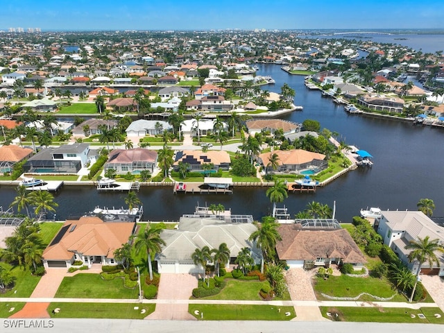 birds eye view of property with a water view and a residential view