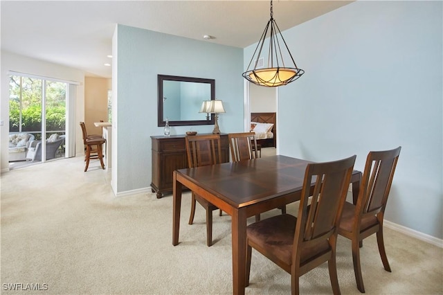 dining space featuring baseboards, recessed lighting, and light colored carpet