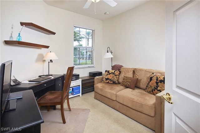 home office featuring light carpet and ceiling fan