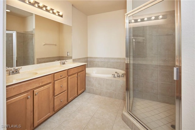 full bathroom with a garden tub, tile patterned flooring, a sink, and a stall shower