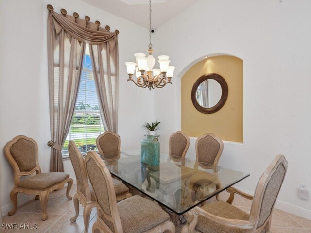 tiled dining area featuring a notable chandelier