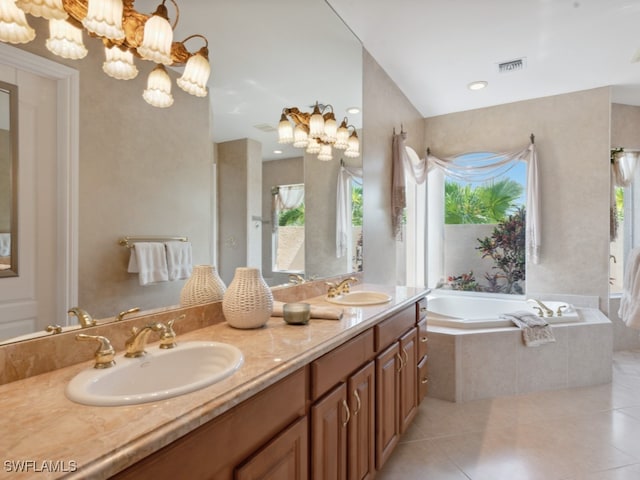 bathroom featuring tile patterned floors, double vanity, plenty of natural light, and tiled bath