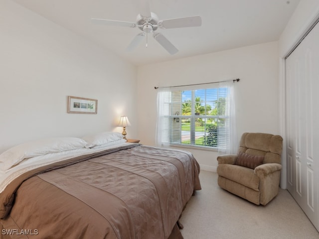 carpeted bedroom featuring a closet and ceiling fan