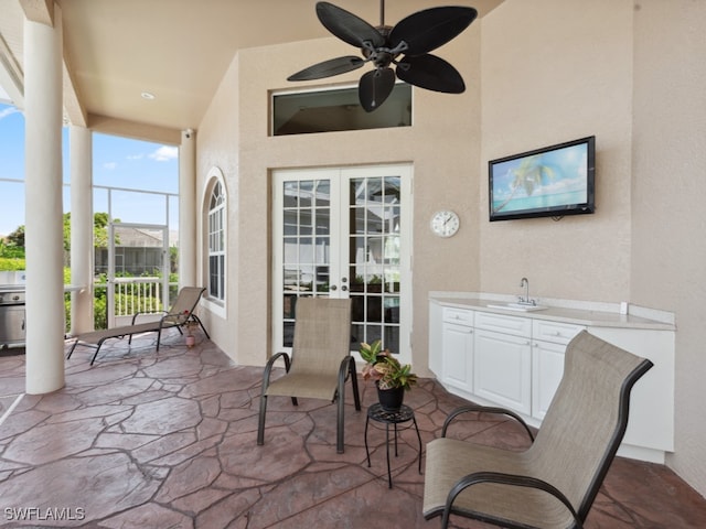 view of patio with ceiling fan and sink