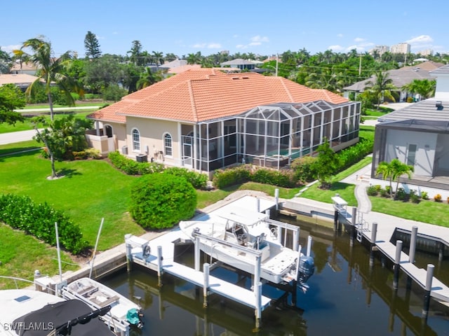 view of dock with a water view, a lanai, and a lawn