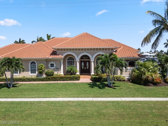 mediterranean / spanish house with a front lawn